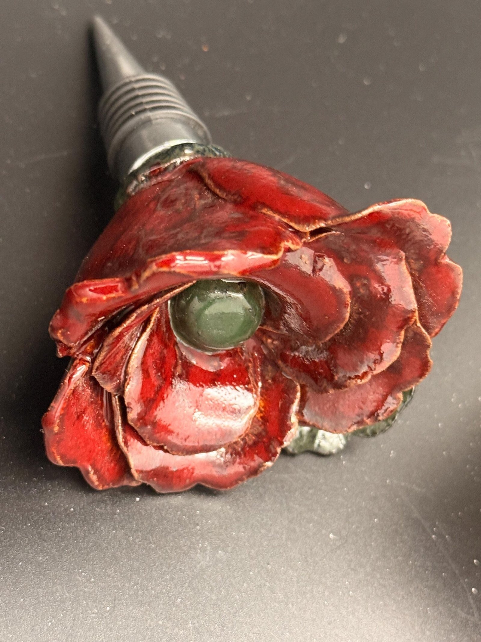 Hand sculpted, ceramic rose wine stopper.