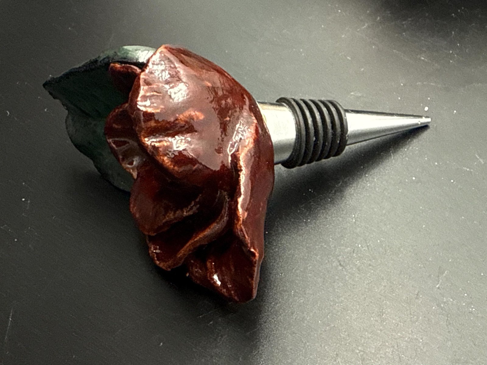 Hand sculpted, ceramic rose wine stopper.